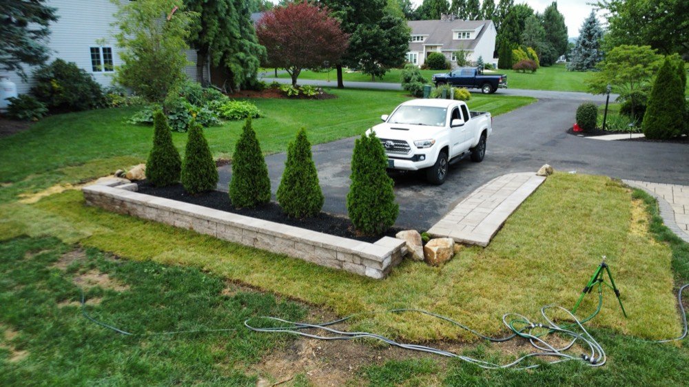 Aerial view of a Bechtel's Landscaping crew truck on site during a hardscape installation