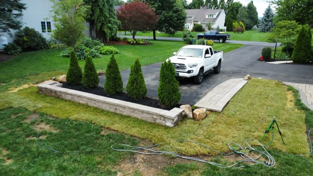 Aerial view of a Bechtel's Landscaping crew truck on site during a hardscape installation
